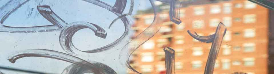 Storefront glass protected by clear anti-graffiti film to guard against vandalism